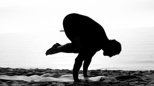 Bakasana Crow pose Yoga at the beach